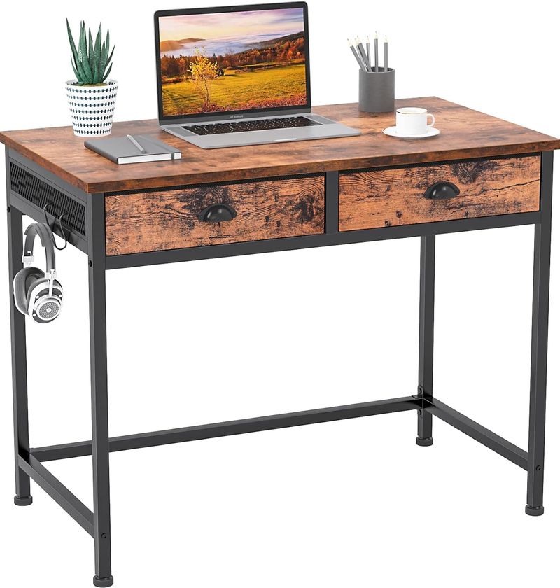 Industrial looking desk made of painted black metal and stained wood with two drawers.