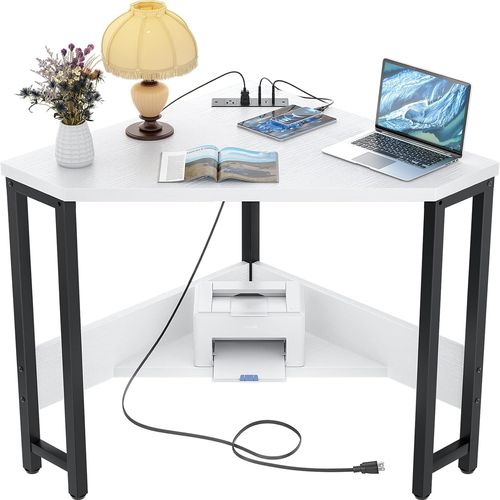 Small white triangle shaped corner desk with outlets and USB ports.