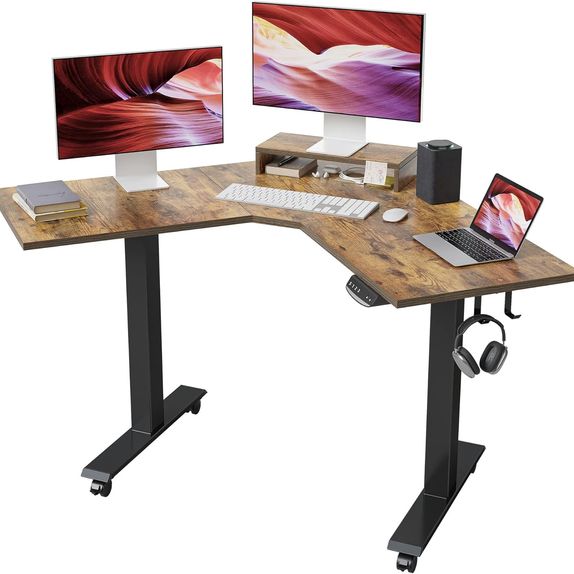 Electric sit stand desk with black metal legs and a wooden desk top holding two screens, a laptop and peripherals.