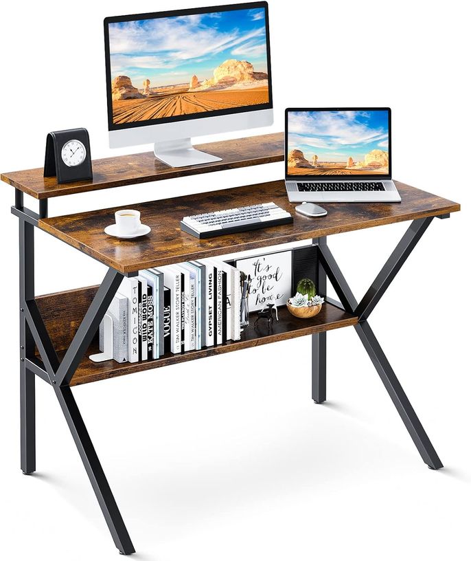 Industrial looking desk made of painted black metal and stained wood with book storage underneath and a monitor raiser.
