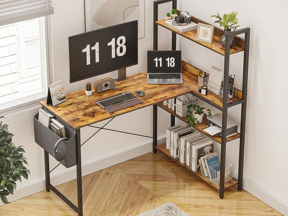 Wood and metal corner desk setup with integrated shelves for books and plants