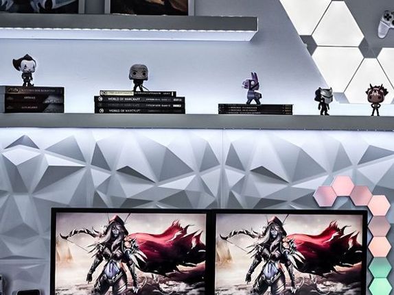 Highly detailed all white gamer desk setup with posters and figurines