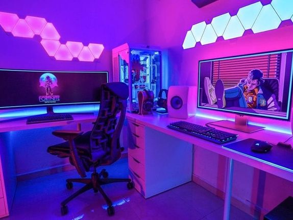 Vibrant Neon Purple Vaporwave inspired desk setup for dual purpose as a console and pc gaming space