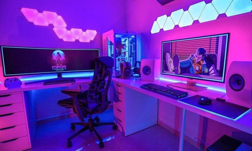 Vibrant Neon Purple Vaporwave inspired desk setup for dual purpose as a console and pc gaming space